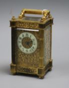 An ornate brass carriage timepiece