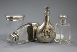 A silver perfume flask with monogram, two silver-mounted toilet bottles and a silver-mounted glass