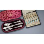 Two cased sets - six white metal and enamel teaspoons and a Victorian three piece silver Christening