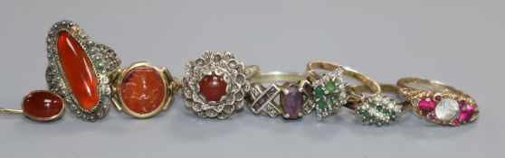 A signet ring with carnelian matrix, a carnelian stick pin, a 9ct gold scroll-carved ring and four