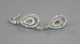 A modern pair of 18ct white gold and diamond set pear shaped drop earrings, overall 27mm.