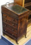 A Regency rosewood davenport of small proportions, the swivel top with leather-inset slope, brass