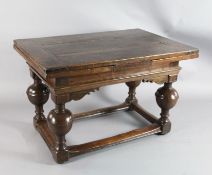 A mid 17th century Dutch oak draw leaf table with rectangular top raised on four baluster legs