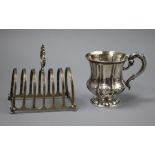 A George IV silver christening mug (a.f.) and a silver seven bar toastrack.