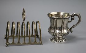 A George IV silver christening mug (a.f.) and a silver seven bar toastrack.