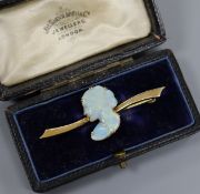 An 18ct gold and white opal brooch, the white opal carved as the bust of a lady to dexter,