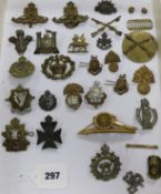 A collection of twenty five assorted cap and other uniform badges and two small buttons