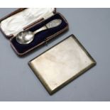 An engine turned silver cigarette case and a cased christening spoon.