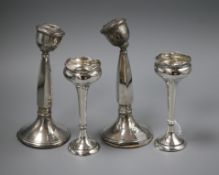 A pair of George V silver posy vases and a pair of damaged silver candlesticks.