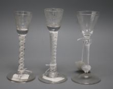 Two 18th century cordial glasses and a similar wine glass, the wine with bell-shaped bowl on knopped
