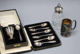 A cased silver christening egg cup and spoon, a set of six silver teaspoons, a silver christening