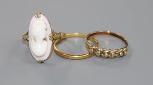 A 22ct gold wedding band, a 9ct gold ring and a yellow metal cameo ring.