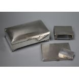 An engine turned silver cigarette case, a silver pill box, a silver matchbox sleeve and silver