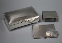 An engine turned silver cigarette case, a silver pill box, a silver matchbox sleeve and silver