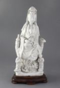 A Chinese Dehua blanc de chine group of Guanyin with child and attendants, 17th/18th century 36cm,