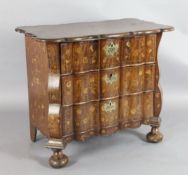 An early 19th century Dutch walnut and marquetry serpentine chest, inlaid with flowers in an urn and