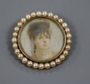 A yellow metal and split pearl mounted circular miniature portrait brooch, 41mm.