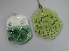 A carved jade pendant and a carved bowenite pendant.