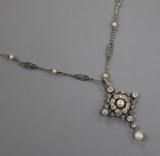 A Belle Epoque platinum, diamond and pearl pendant necklace, the lozenge-shaped openwork pendant