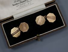 A cased pair of engine turned 9ct gold octagonal cufflinks.