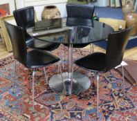 A glass circular breakfast table and a set of four leather and tubular chrome dining chairs W.100cm