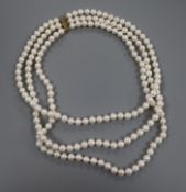 A modern triple strand cultured pearl necklace with yellow metal clasp, 44cm.