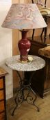 A wrought iron circular tripod table and a lamp W.49.5cm