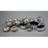 A silver three piece condiment set, three pairs of silver condiments, one other condiment and four