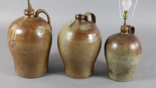 Three saltglaze stoneware flagons, with wide strap handles, fitted for electricity, tallest 18in.