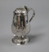 A late 19ct century Hanau? repousse white metal mustard pot (a.f.), 13cm