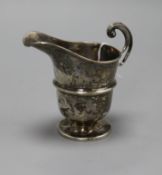 A George V silver helmet shaped cream jug.