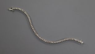 An 18ct white gold and diamond line bracelet, set with fifty four stones with an estimated total