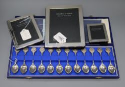 A set of silver Twelve Zodiac Spoons by John Pinches and three silver photograph frames, various,