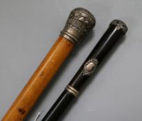 A malacca walking cane with Indian white metal embossed finial and a Spanish rosewood cane with
