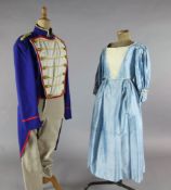 L'Elisir d'Amore: A rail of Royal blue tail coats with red and gold trim, a quantity of peasant