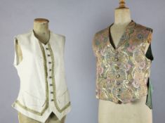 A collection of fifteen mostly patterned gentlemen's waistcoats together with three black leather