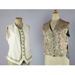 A collection of fifteen mostly patterned gentlemen's waistcoats together with three black leather