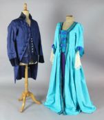 Cosi Fan Tutte: A rail with a blue and green, turquoise and green, gold and orange dresses, a blue
