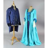 Cosi Fan Tutte: A rail with a blue and green, turquoise and green, gold and orange dresses, a blue