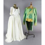 Don Giovanni: A rail with a mint green tail coat and yellow waistcoat and tights, a purple gold