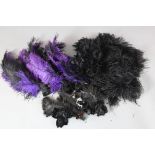 A collection of black feathers and two feather boas