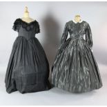 La Traviata: A rail with a collection of 19th century style dresses in black velvet, grey silk, a