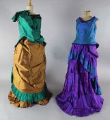 The Merry Widow: A rail with a purple and green dress, two similar dresses in green and brown and