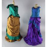 The Merry Widow: A rail with a purple and green dress, two similar dresses in green and brown and