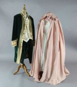The Marriage of Figaro: A rail of green velvet gold trimmed tail coats and trousers, similar pale