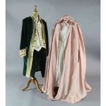 The Marriage of Figaro: A rail of green velvet gold trimmed tail coats and trousers, similar pale