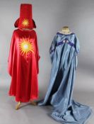 The Magic Flute: Two brightly coloured satin appliqué cloaks, a blue appliqué dress, two leather
