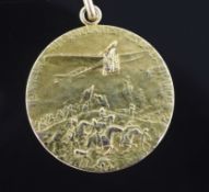 A 14k gold aviation medal inscribed "Honneur Aux Vaillants Fils De La France".