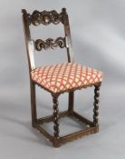 A late 17th century French oak rail back chair, with eagle head cresting and scroll mid bar, over-