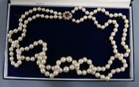 A double string graduated cultured pearl necklace with 9ct gold, pearl and gem set clasp, 52cm.